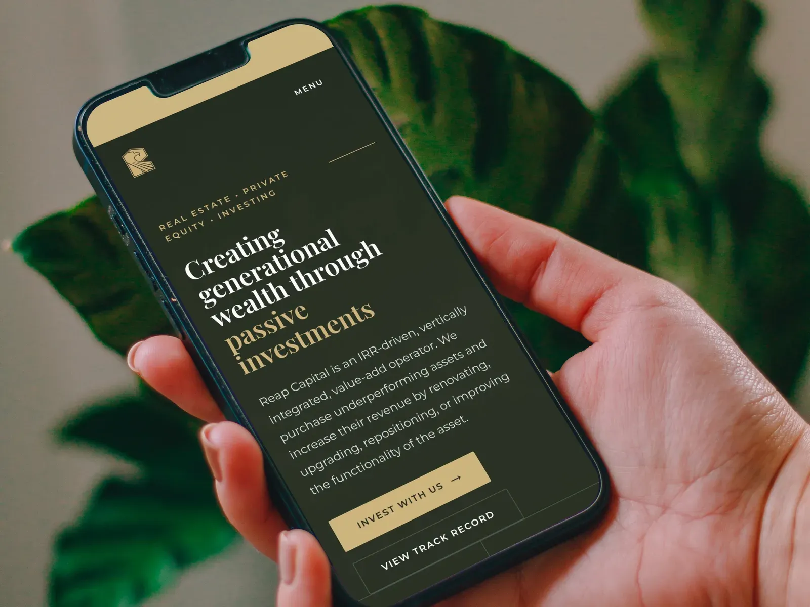 The homepage hero on a phone, held in one hand