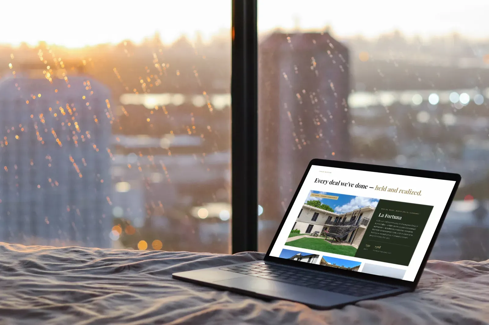 The track record page on a laptop, in front of a rainy city window